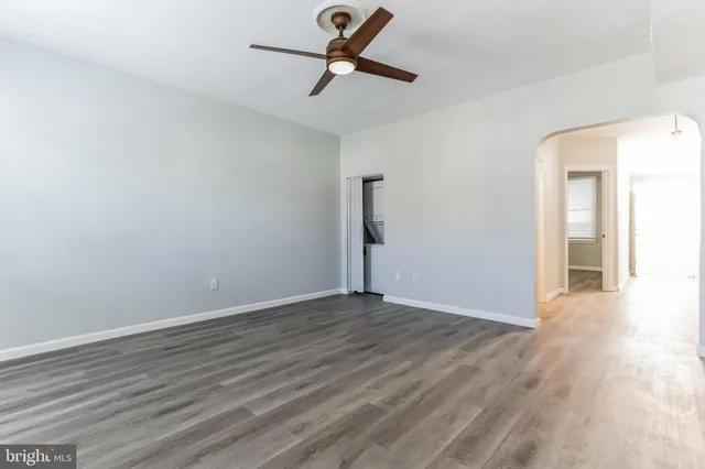 a view of a kitchen with refrigerator and wooden floor