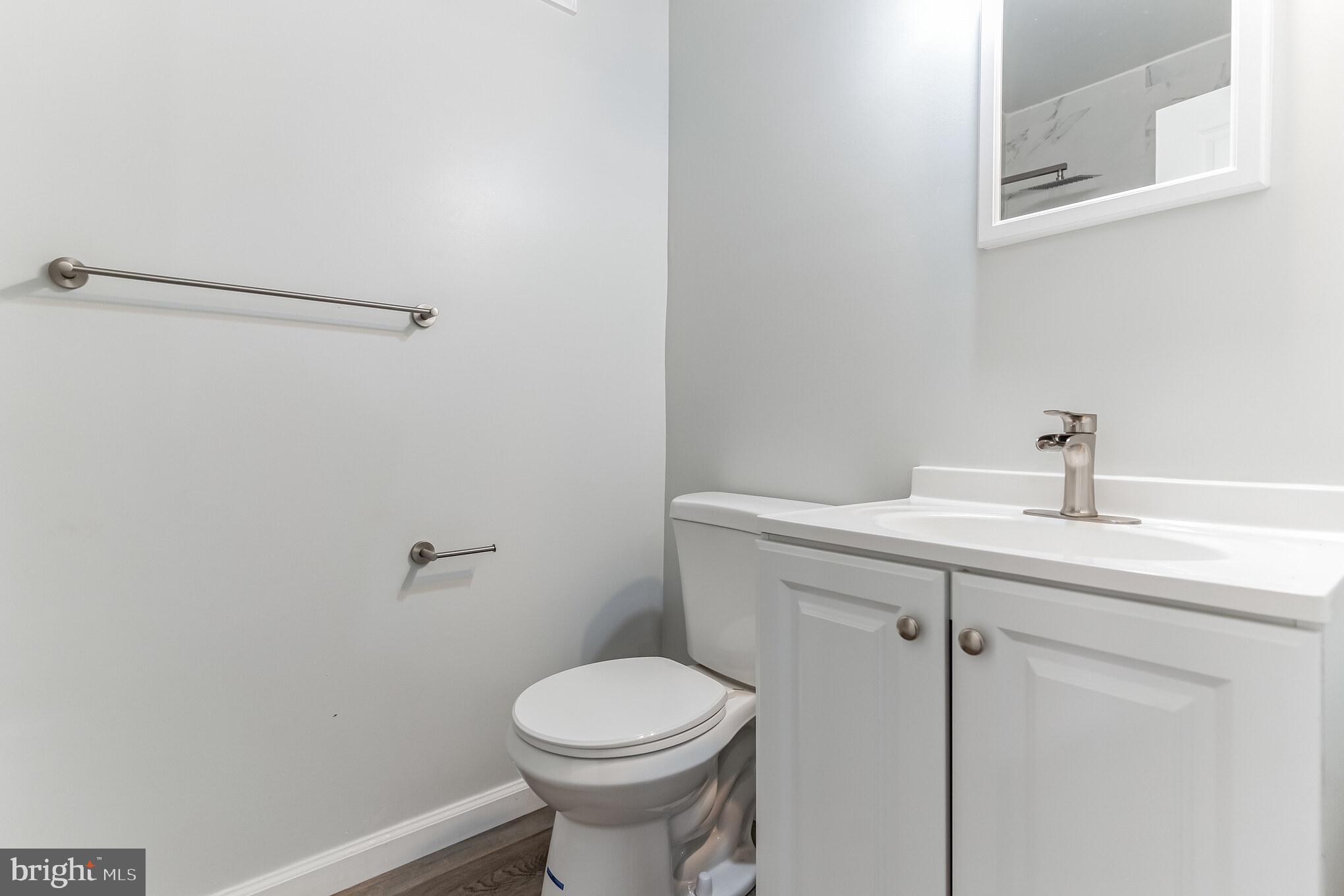 1223 Simms Place Northeast, Unit 1 Washington, DC 20002 - Photo 35 of 48 a bathroom with a sink mirror and toilet