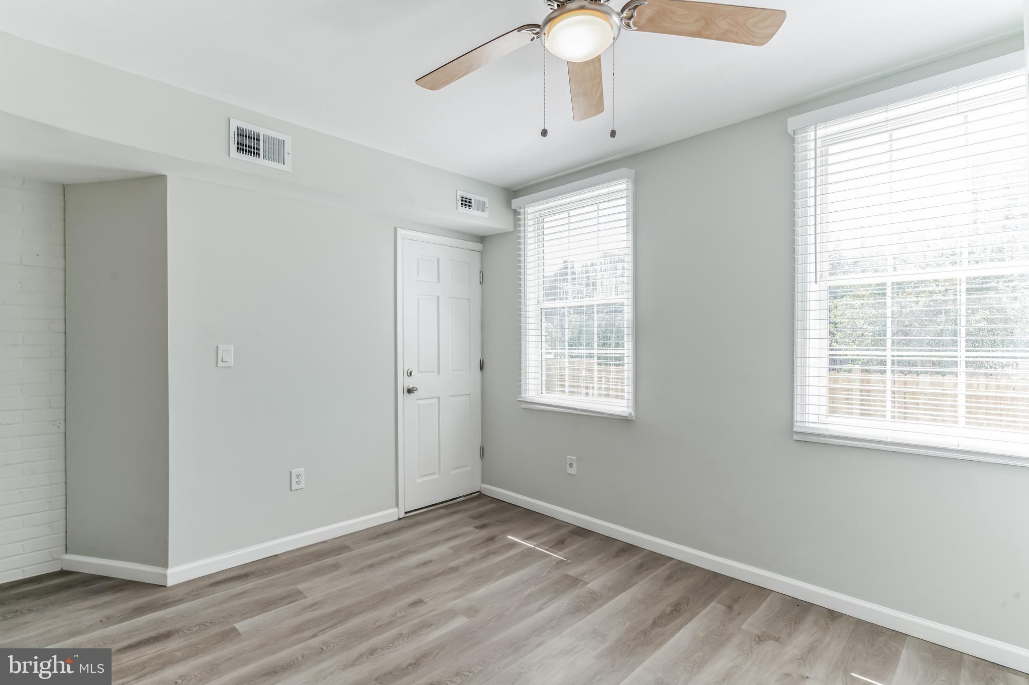 1223 Simms Place Northeast, Unit 1 Washington, DC 20002 - Photo 39 of 48 a view of an empty room with wooden floor and a window