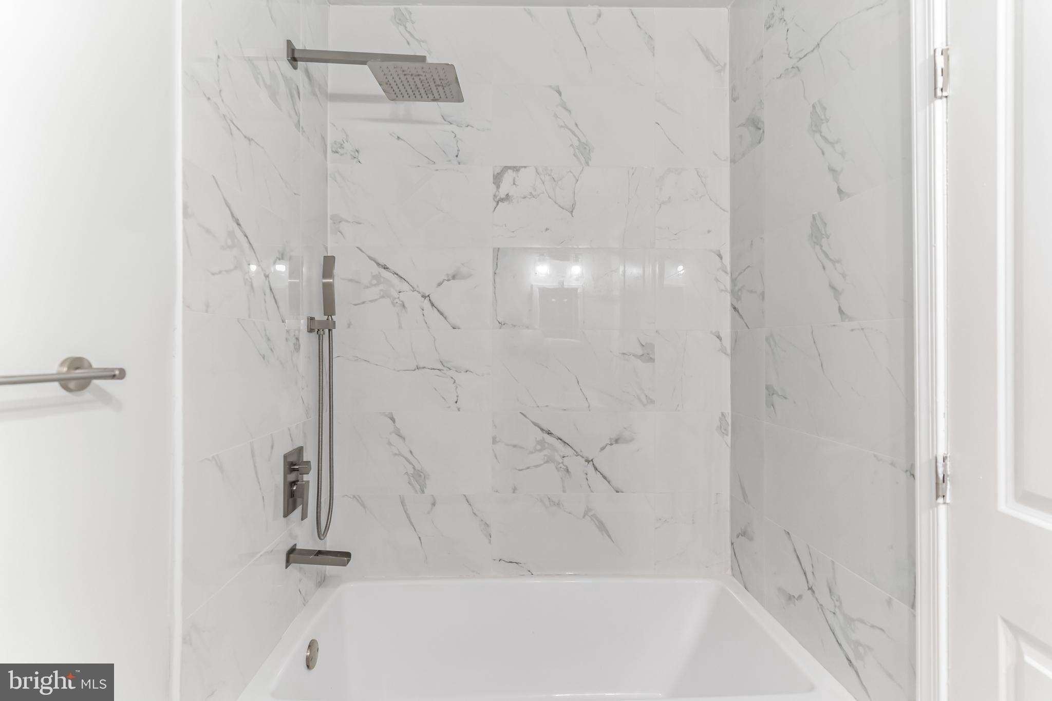 1223 Simms Place Northeast, Unit 1 Washington, DC 20002 - Photo 7 of 48 a bathroom with a bathtub