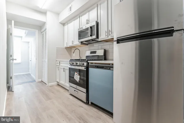 a kitchen with cabinets and steel stainless steel appliances