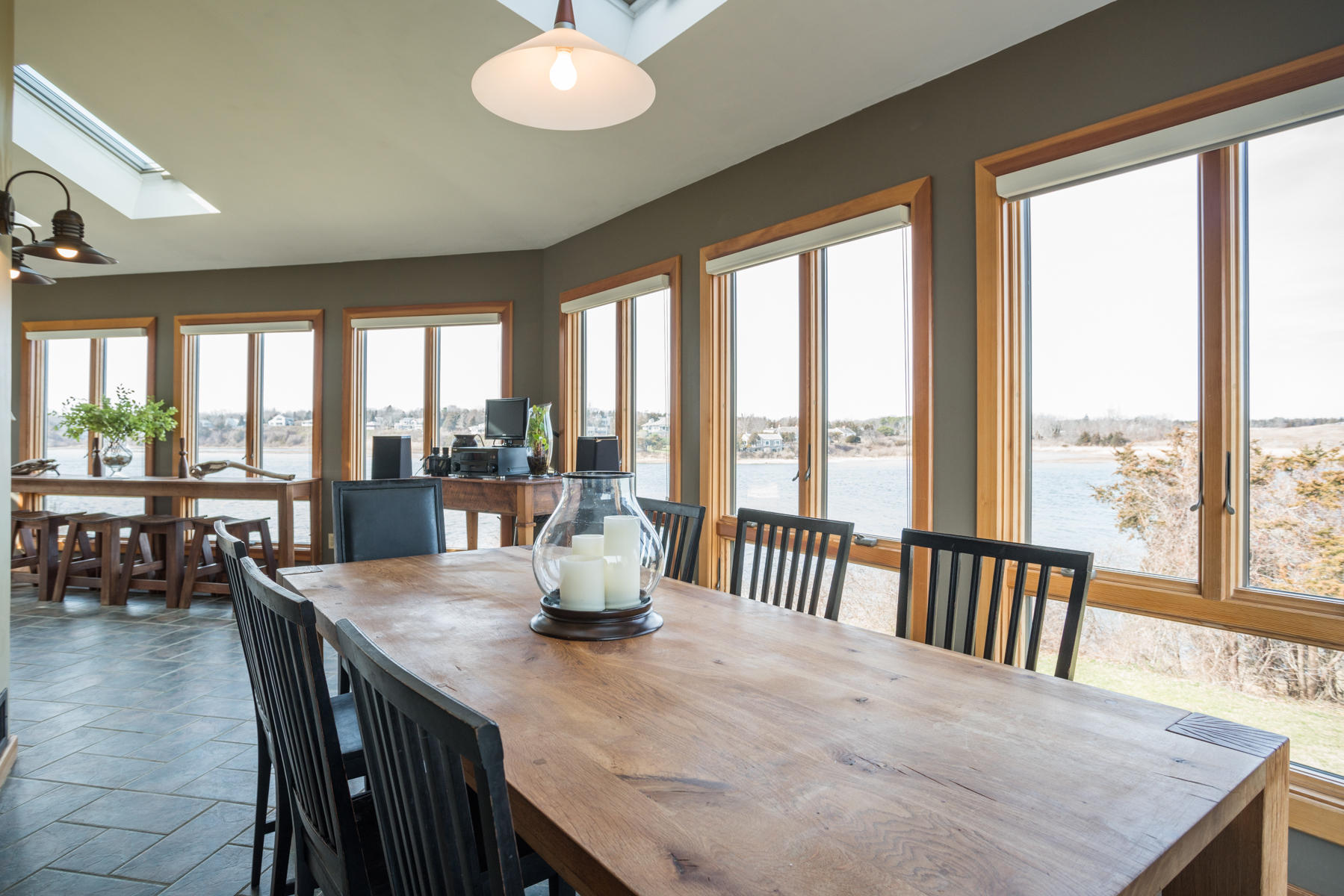 100 Freeman Lane Orleans, MA 02653 - Photo 7 of 34 a view of a dining room with furniture large windows and wooden floor