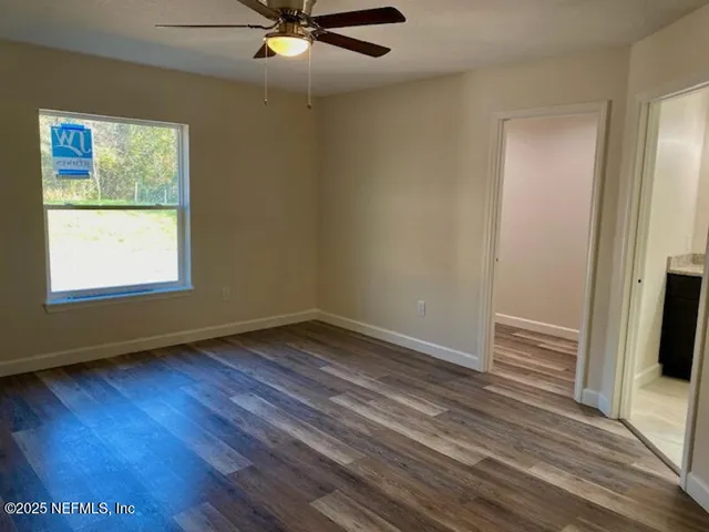 a bathroom with double vanity sinks and a mirror