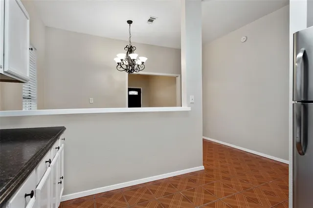a view of a kitchen with a sink and dishwasher with wooden floor