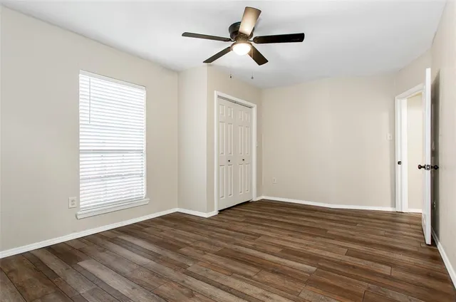 a view of backyard with wooden fence