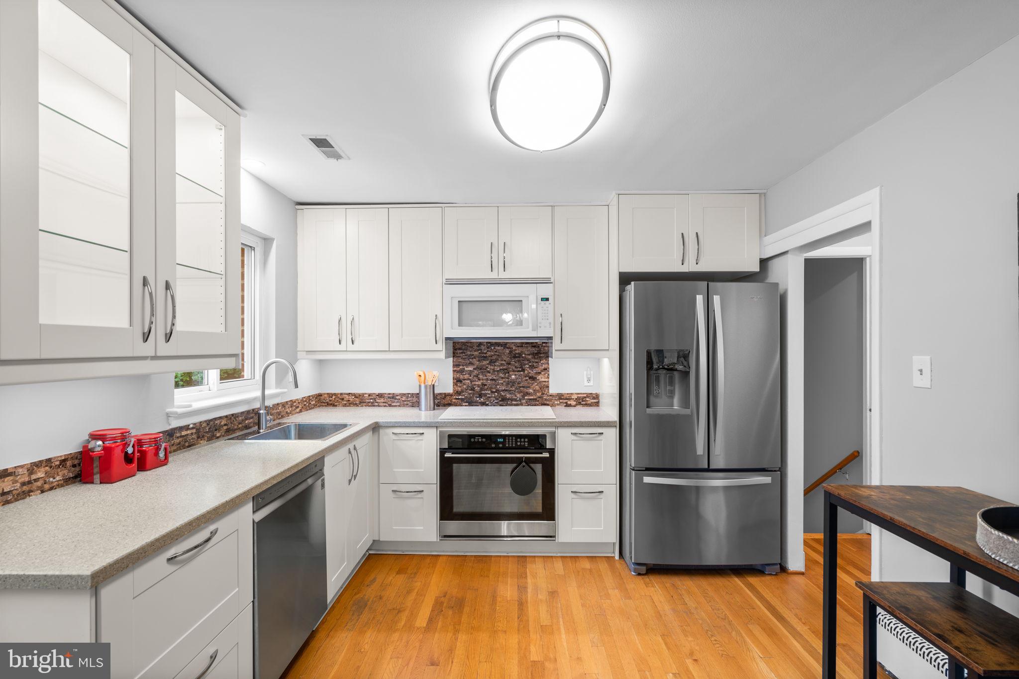 2306 Barbour Road Falls Church, VA 22043 - Photo 12 of 37 a kitchen with a refrigerator sink and cabinets