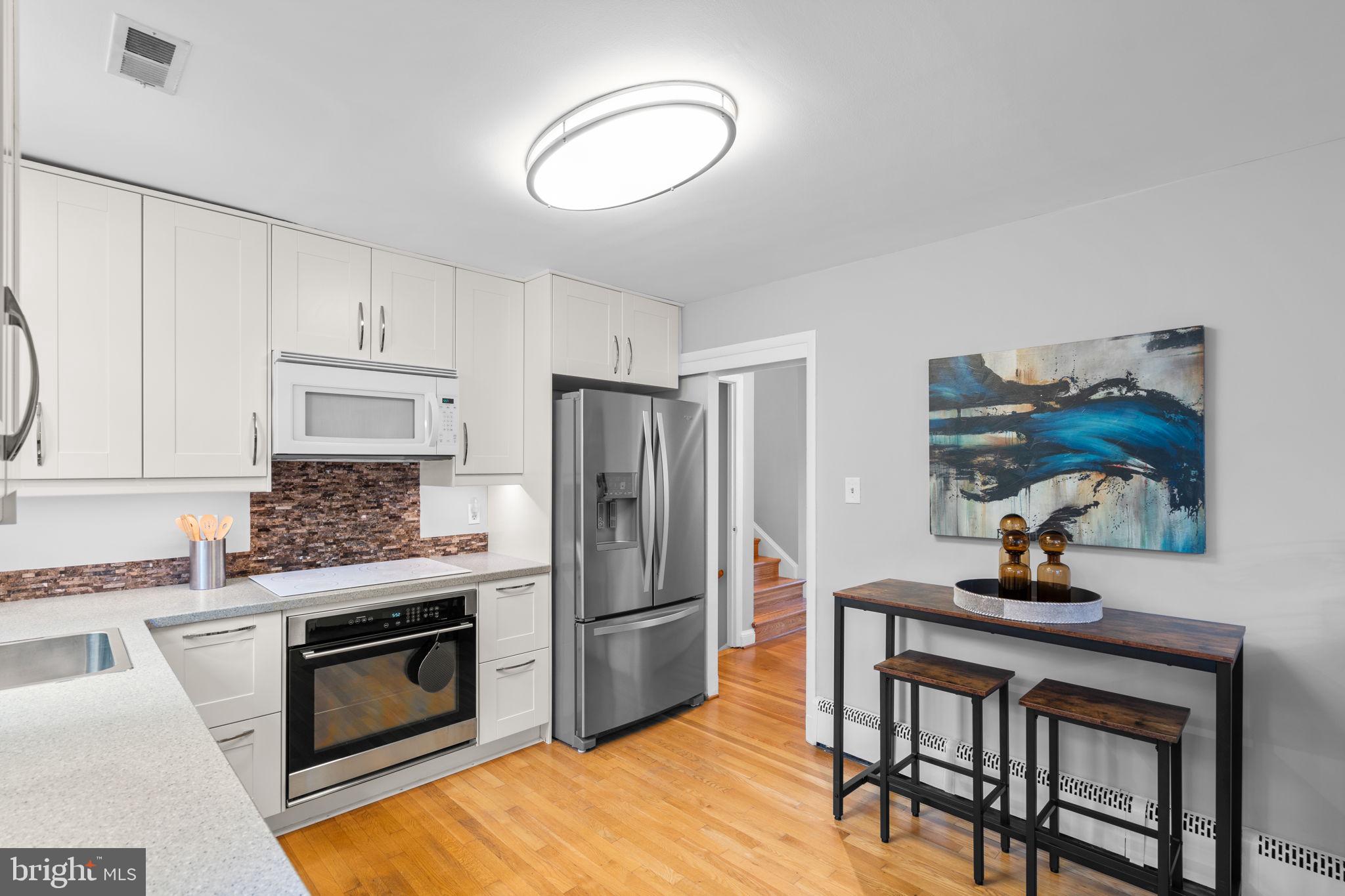 2306 Barbour Road Falls Church, VA 22043 - Photo 14 of 37 a kitchen with a stove a refrigerator and a microwave