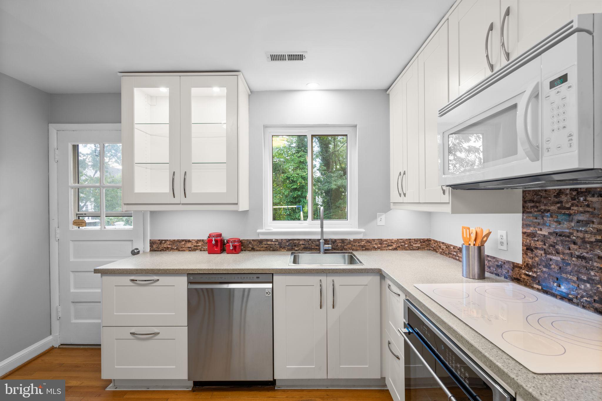 2306 Barbour Road Falls Church, VA 22043 - Photo 17 of 37 a kitchen with a sink stove and cabinets