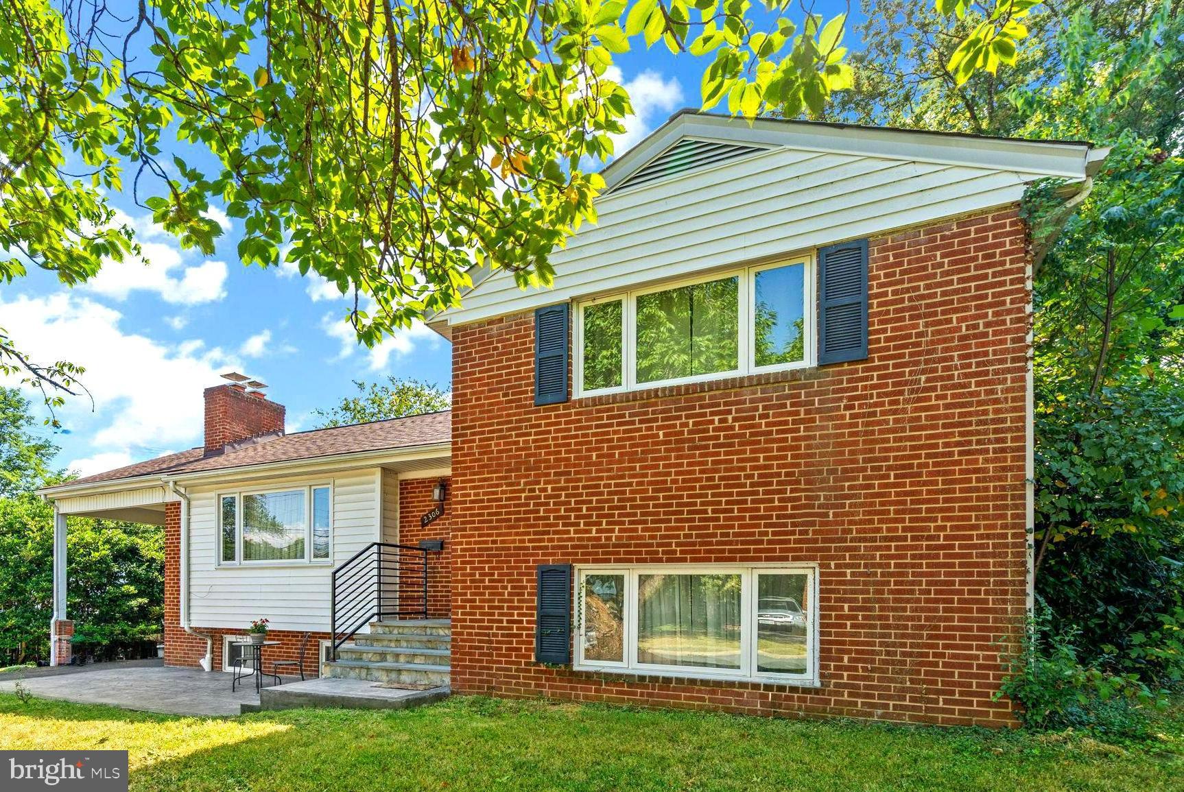 2306 Barbour Road Falls Church, VA 22043 - Photo 4 of 37 a front view of a house with a yard and garage