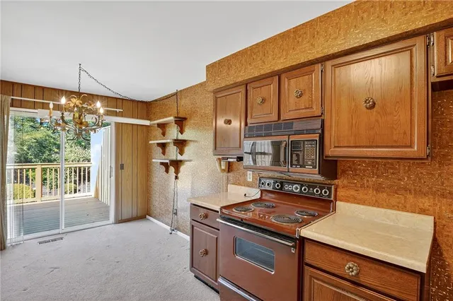 a kitchen with a stove and a refrigerator