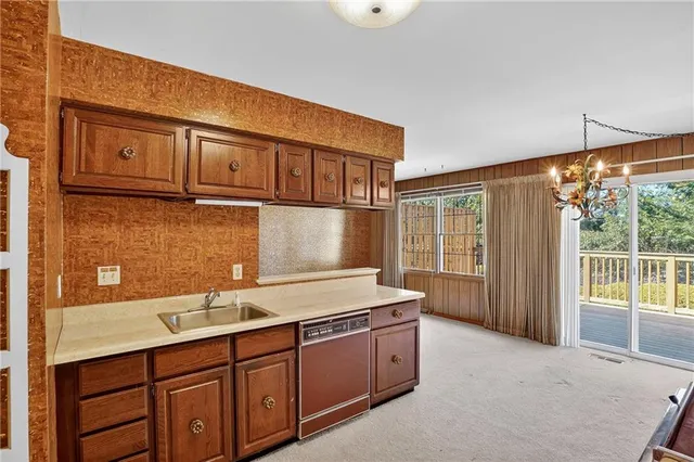 a kitchen with a sink and a large window