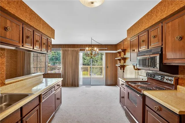 a kitchen with stainless steel appliances granite countertop a stove and a refrigerator