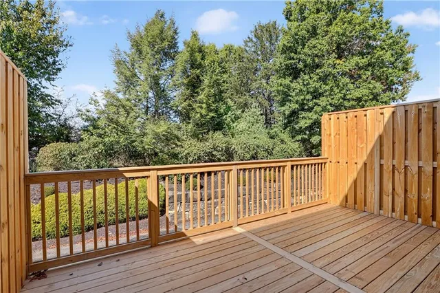a balcony with wooden floor and fence
