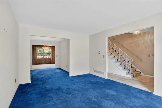 an empty room with windows and entryway