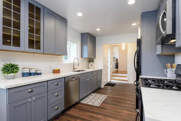 a kitchen with sink cabinets and appliances