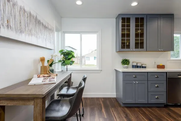 a view of a kitchen with a table and chairs