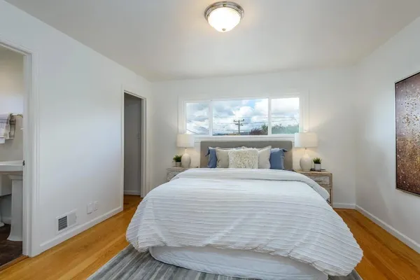 a bedroom with a bed and window