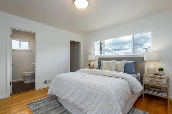 a bedroom with a bed and a window