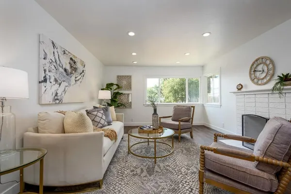 a living room with furniture and a fireplace