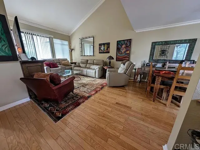 a living room with furniture windows and wooden floor