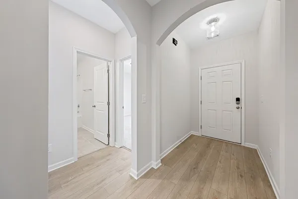 a view of a hallway with wooden floor