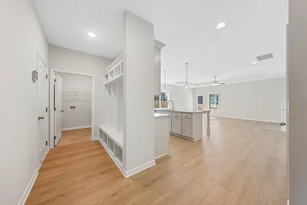 a view of a kitchen with wooden floor and electronic appliances