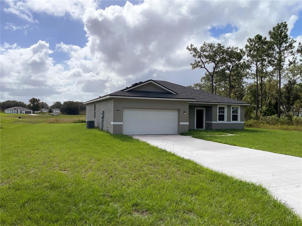 6038 Southwest 154th Place Road Ocala, FL 34473 - Photo 1 of 1 a front view of a house with garden