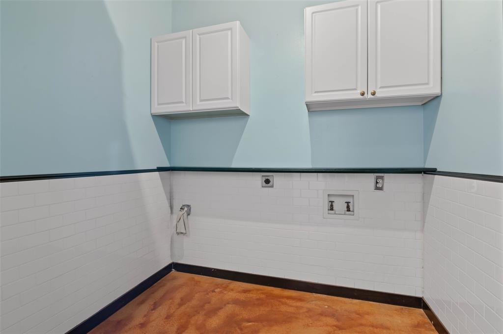 1122 Jackson Street, Unit 313 Dallas, TX 75202 - Photo 19 of 27 a view of a kitchen with an empty space and cabinets