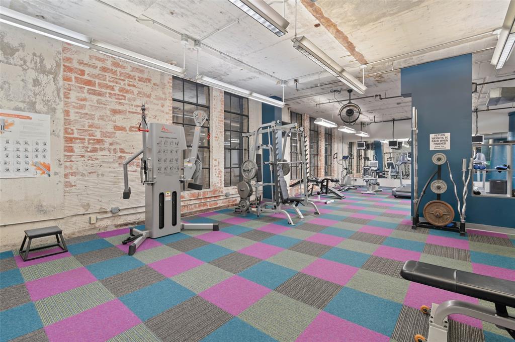 1122 Jackson Street, Unit 313 Dallas, TX 75202 - Photo 25 of 27 a room with gym equipment and a table