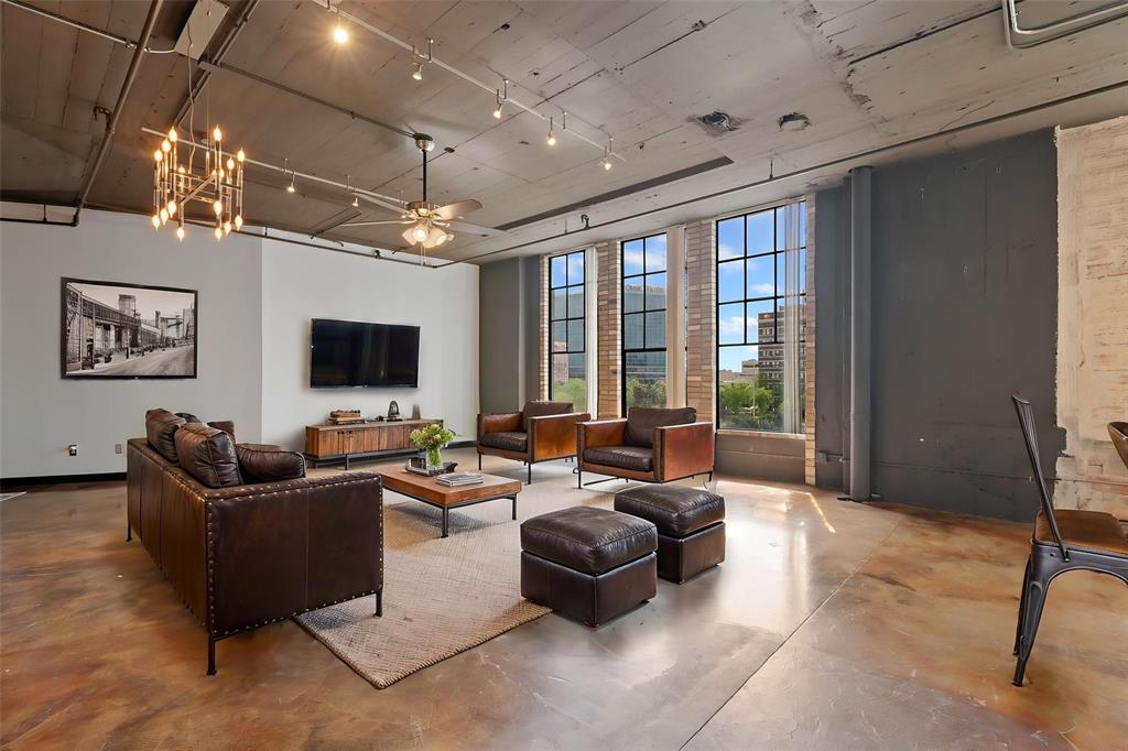 1122 Jackson Street, Unit 313 Dallas, TX 75202 - Photo 9 of 27 a living room with furniture and a flat screen tv