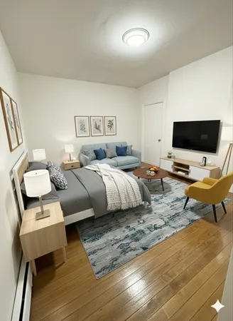 a bedroom with a bed and wooden floor