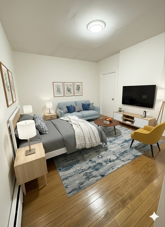 36 Sagamore Street, Unit 3 Lynn, MA 01902 - Photo 11 of 19 a bedroom with a bed and wooden floor