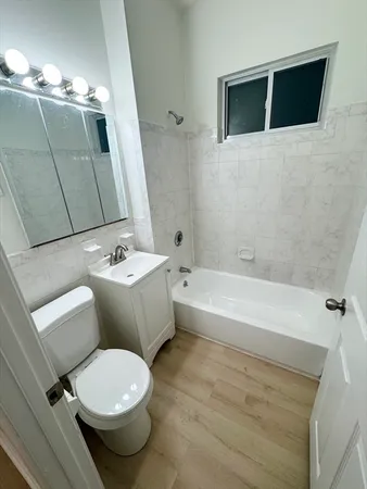 a bathroom with a toilet a sink and bathtub