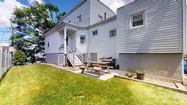 a view of a house with backyard porch and sitting area