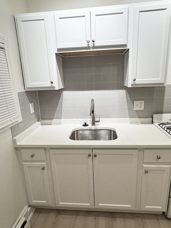 36 Sagamore Street, Unit 3 Lynn, MA 01902 - Photo 3 of 19 a kitchen with a sink and cabinets