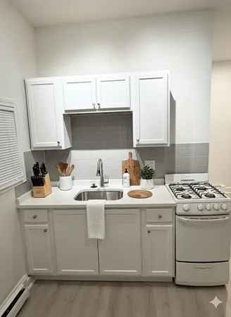 a kitchen with stainless steel appliances granite countertop a sink stove and cabinets