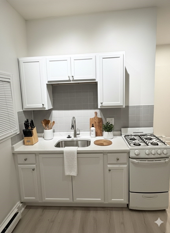 36 Sagamore Street, Unit 3 Lynn, MA 01902 - Photo 4 of 19 a kitchen with stainless steel appliances granite countertop a sink stove and cabinets