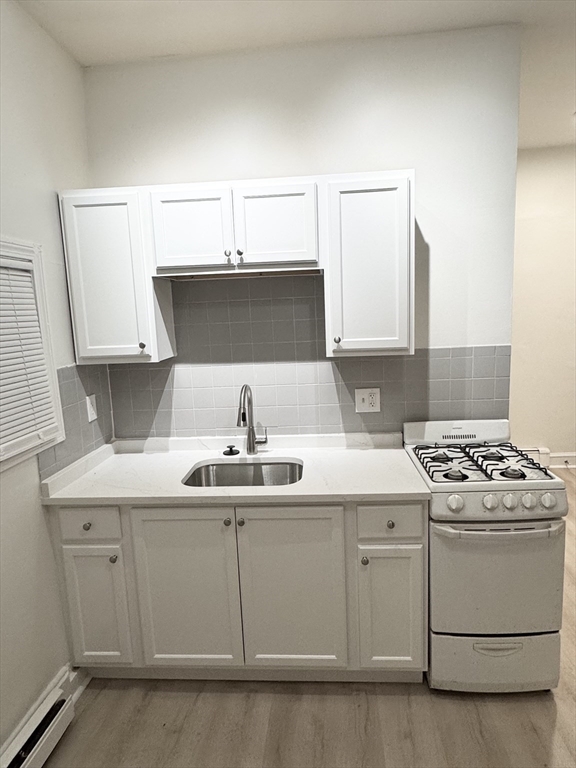 36 Sagamore Street, Unit 3 Lynn, MA 01902 - Photo 5 of 19 a kitchen with a sink a stove and cabinets