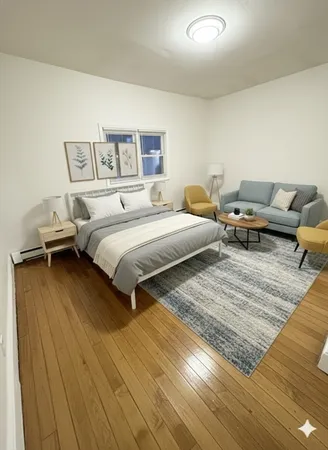 a spacious bedroom with double bed and a couch