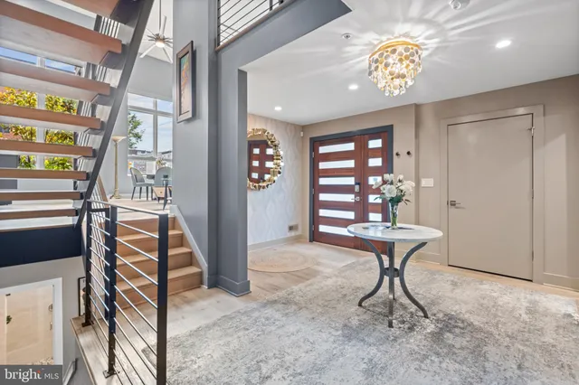 a kitchen with stainless steel appliances wooden floor and a refrigerator