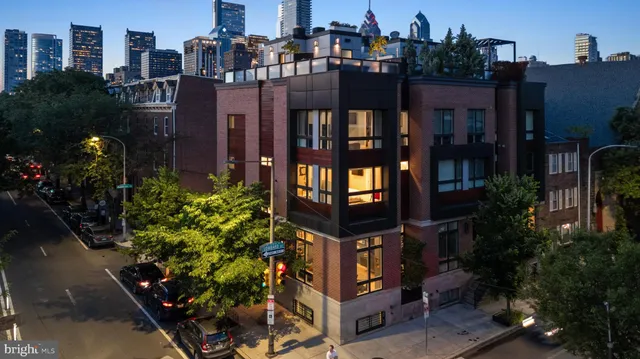 a living room with a couch and a dining table with wooden floor