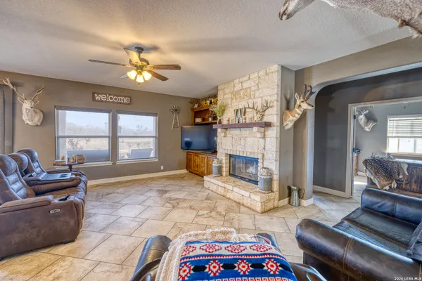 a living room with fireplace furniture and a chandelier