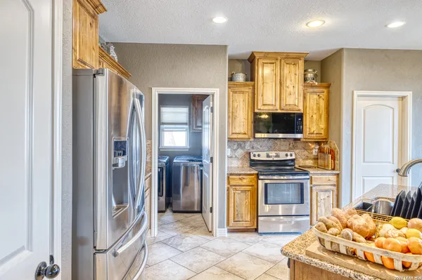 a kitchen with granite countertop a stove and a cabinet