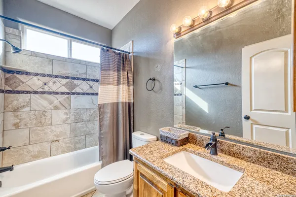 a view of an empty room with a window and a fan