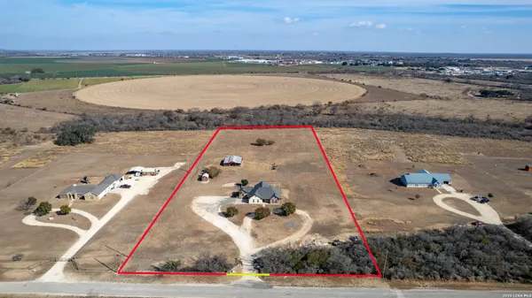 an aerial view of a house with a yard