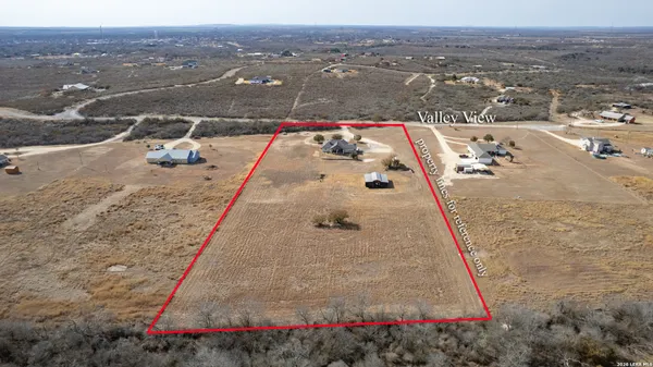 a swimming pool with outdoor seating and lake view