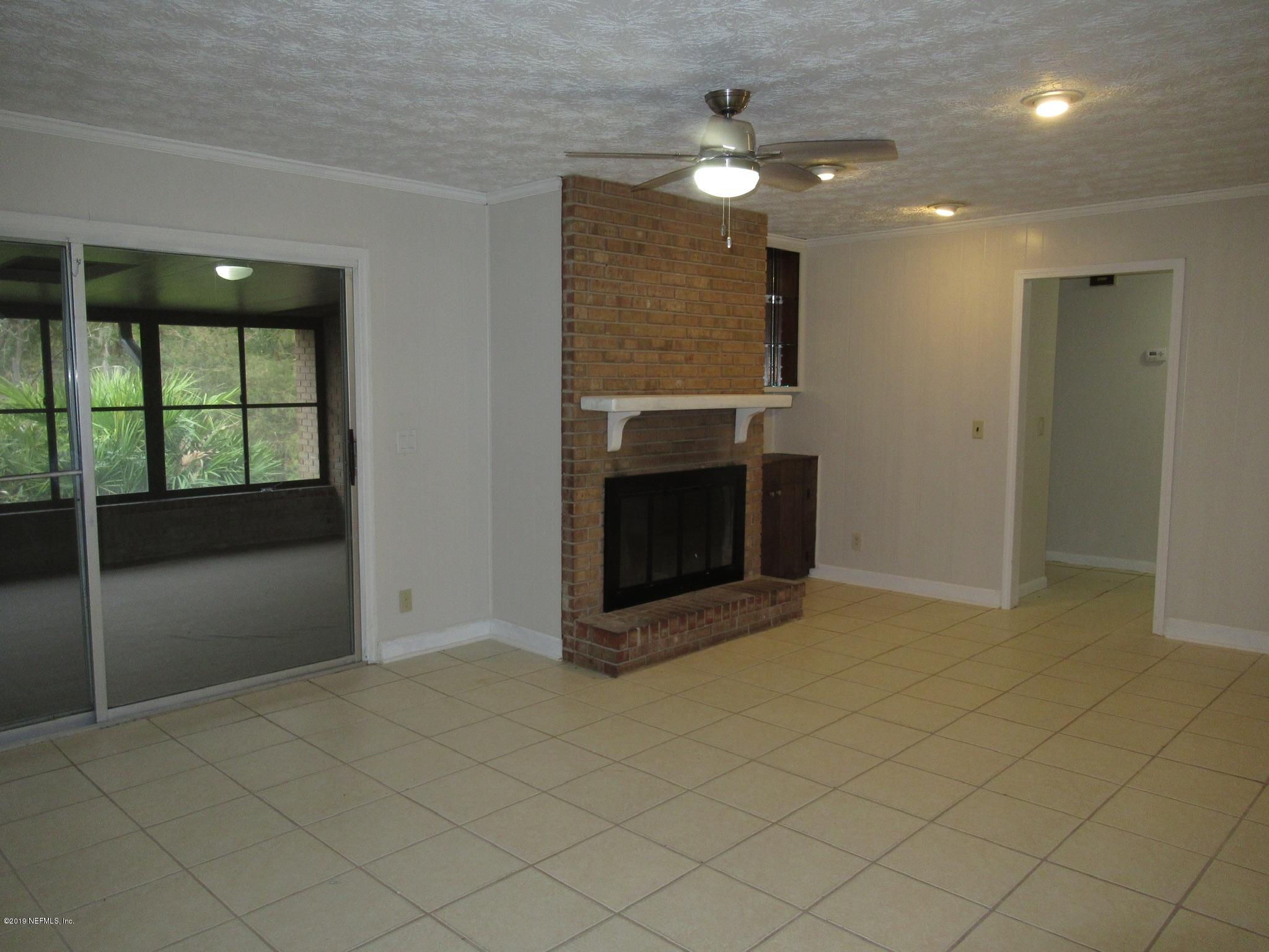 3444 Debussy Road Jacksonville, FL 32277 - Photo 10 of 30 Cozy Living Room w/ Brick Fireplace