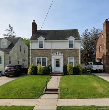 a front view of a house with a garden