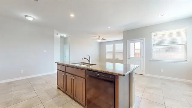 a kitchen with stainless steel appliances granite countertop a sink and a stove
