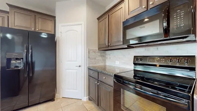 a kitchen with granite countertop cabinets and steel stainless steel appliances